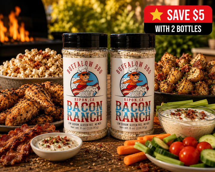 Two bottles of BuffalowBBQ Bacon Ranch seasoning surrounded by chicken wings, bacon, vegetables, dip, and roasted potatoes.