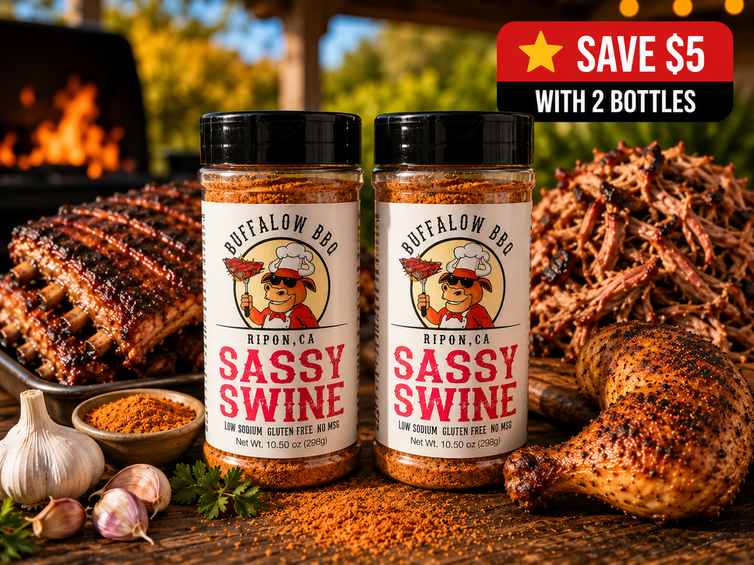 Two bottles of BuffalowBBQ Sassy Swine BBQ seasoning displayed with smoked ribs, pulled pork, grilled chicken, garlic, and seasoning in a backyard barbecue setting with a "Save $5 with 2 Bottles" promotion.