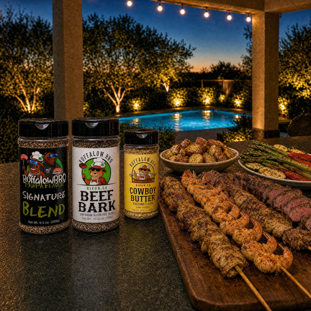BuffalowBBQ Everyday BBQ Rub Bundle: Signature Blend, Beef Bark and Cowboy Butter with grilled shrimp, chicken and steak skewers, potatoes and veggies by the pool at dusk.