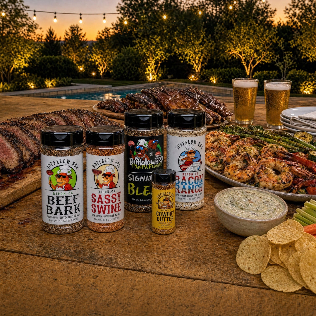 BuffalowBBQ Ultimate BBQ Rub Variety Pack: Beef Bark, Sassy Swine, Signature Blend, Bacon Ranch and Cowboy Butter on a backyard party table at dusk
