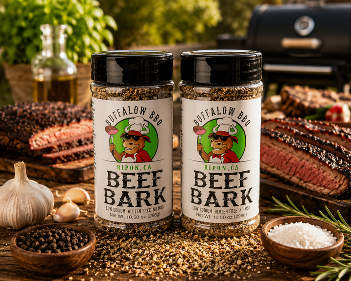 Two bottles of Buffalow BBQ Beef Bark seasoning displayed with sliced brisket on a rustic grilling table.