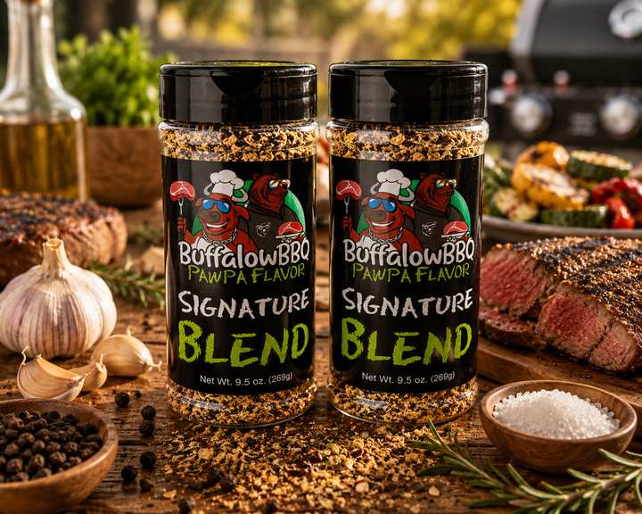 Two bottles of BuffalowBBQ Signature Blend all-purpose seasoning displayed on a rustic wooden table with steak, grilled vegetables, garlic, herbs, and scattered seasoning.